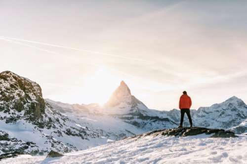 Man standing in the alps in Switzerland in front of the Matterhorn