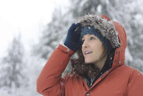 A woman marvels at falling snow