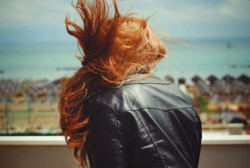 Healthy ginger hair in a windy and sunny day.