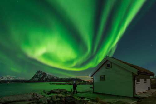 Admiring the show of the Northern Lights in Lofoten Islands, Norway