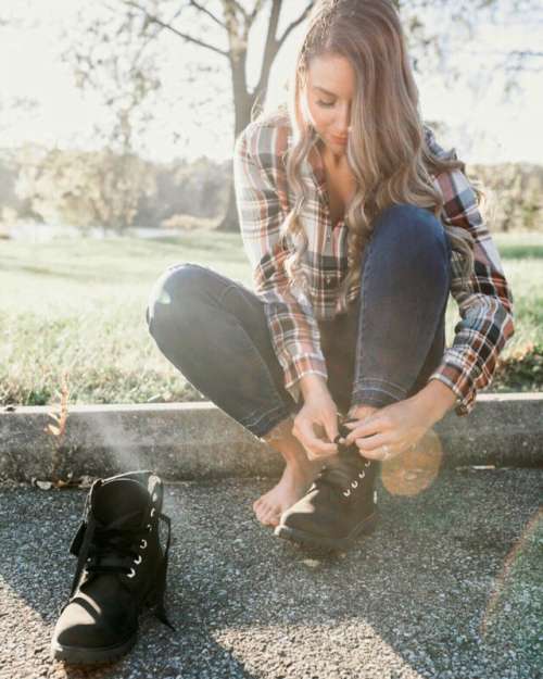 Young woman lacing boots for fall!