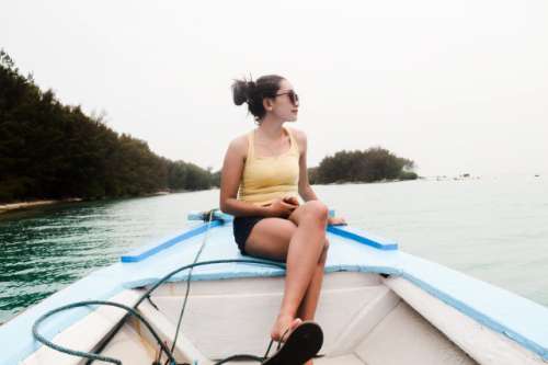 Girl on the boat, with beautiful nature on the background.