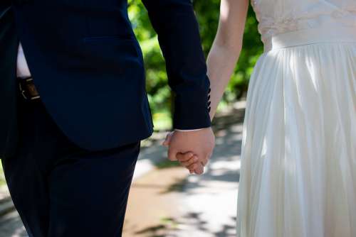 Bride and Groom Holding Hands