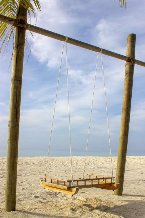 Wood Crafted Swing Placed on the Beach