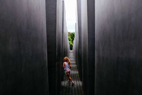 Girl Plays In Concrete Structure Photo