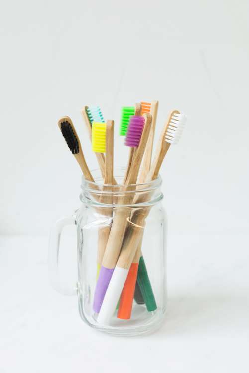 Multi-colored Toothbrushes In Glass Photo