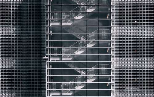 Metal Stairwell Behind Glass Windows Photo