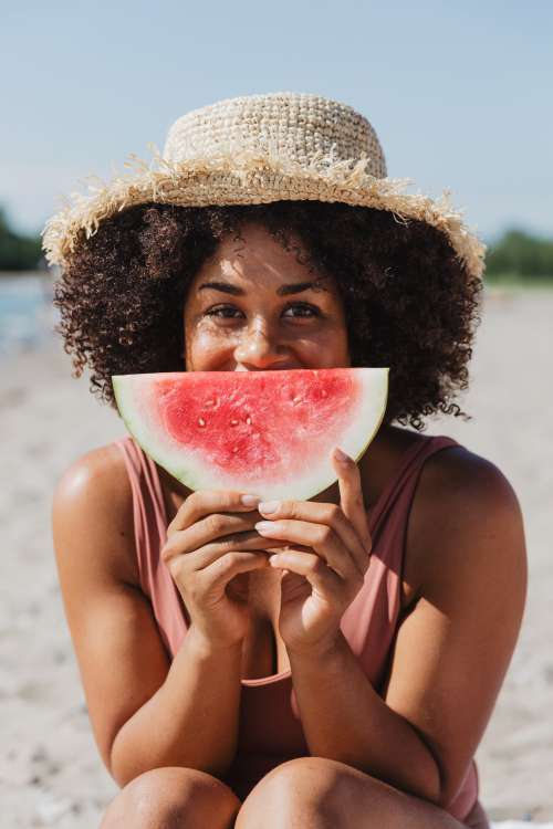 Young Woman Holds Watermelon Slice On Sunny Beach Photo