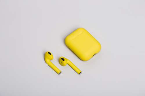 Yellow Earbuds On White Photo