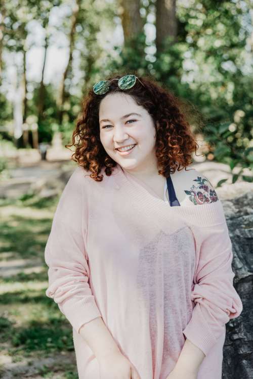 Young Woman With Curly Hair Smiling Bright Photo