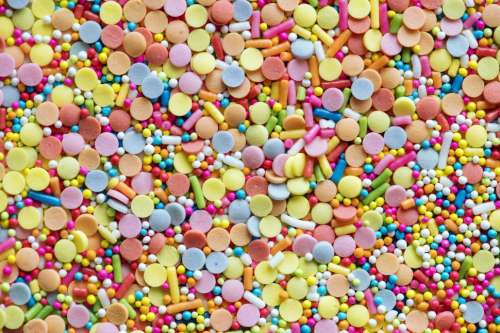 Flat lay of rainbow sparkle candy background