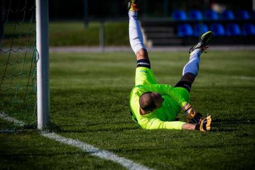 Soccer goalkeeper stretching to stop the ball