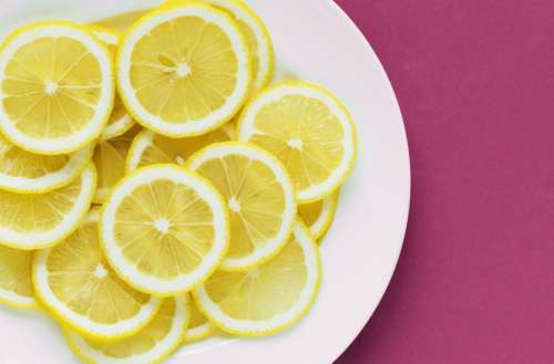 Flat lay of lemon slices on white plate