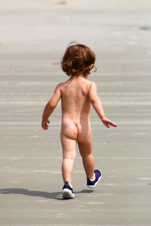 Toddler playing on the beach