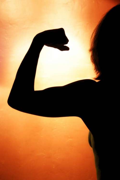 Healthy Woman Flexes Muscles