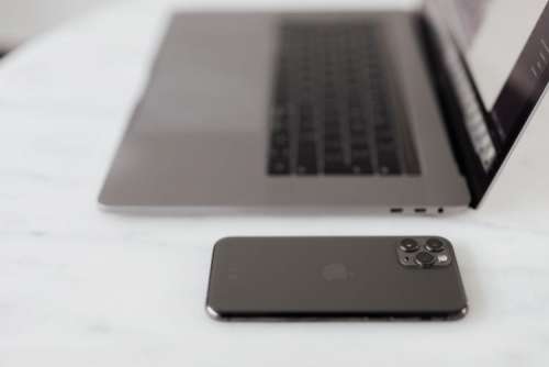 MacBook Pro 15 laptop and iPhone 11 Pro on a marble table