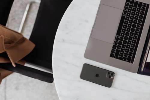 MacBook Pro 15 laptop and iPhone 11 Pro on a marble table
