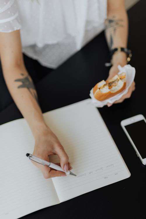 A businesswoman works at a desk with a laptop