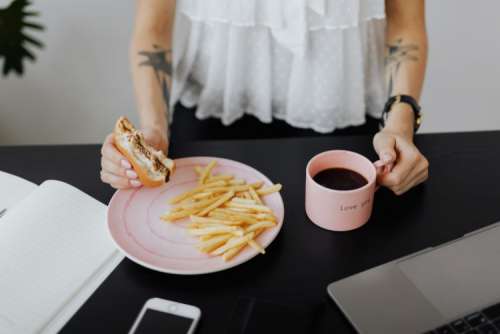 A businesswoman works at a desk with a laptop