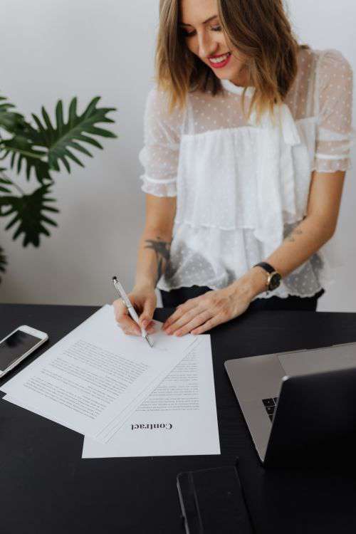 A businesswoman works at a desk with a laptop