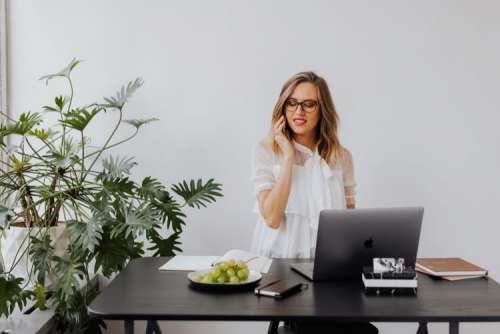 A businesswoman works at a desk with a laptop