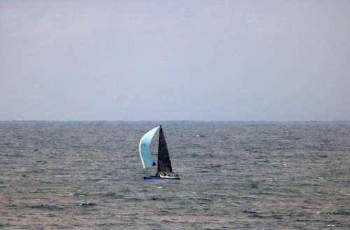Yacht With Light Blue Sail