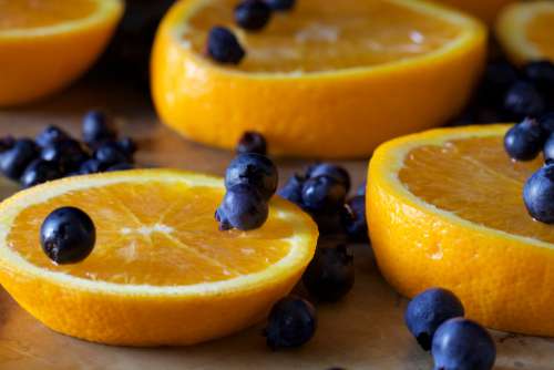 sliced oranges fruit blueberries table