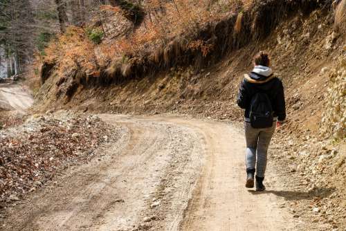 Girl Walking on a Mountain Path