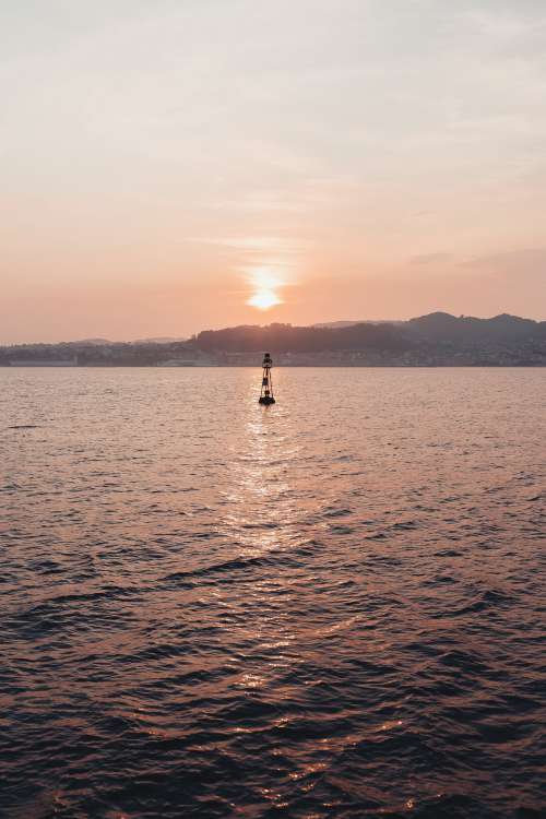 Buoy At Sunset Photo