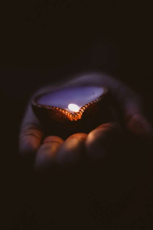 Diwali Candle Lies In The Palm Of A Hand Photo