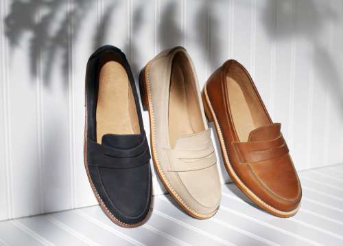 Loafers Leaning Along White Wall Photo