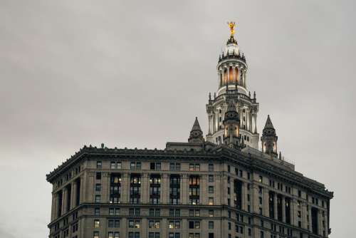 Golden Statue On Top Of Tower Photo