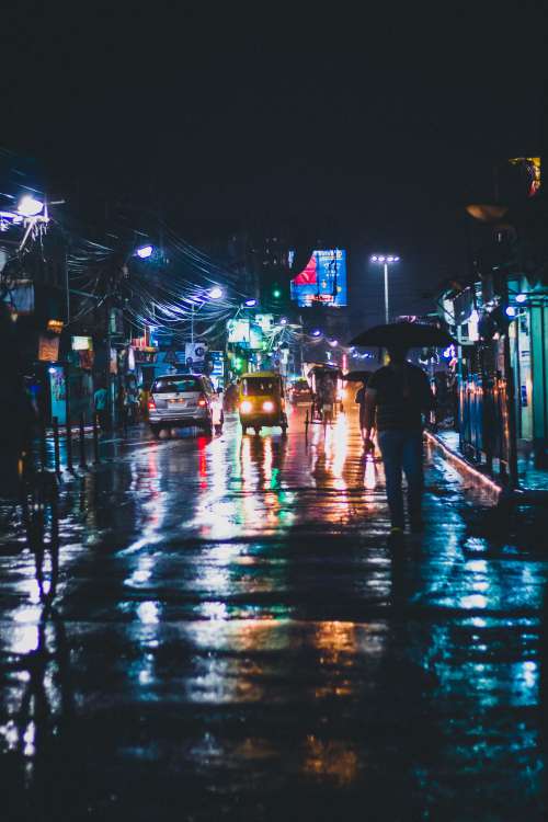 Street Lights Reflect On Wet City Streets In India Photo
