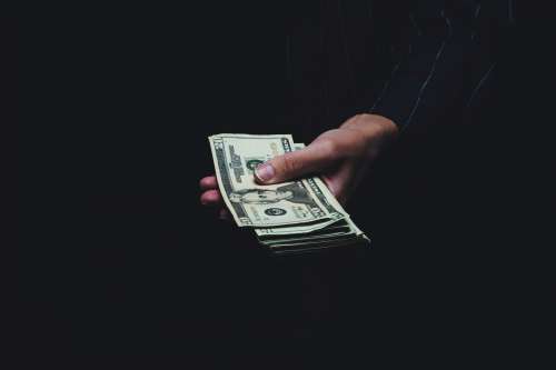 Holding A Stack Of Money Photo