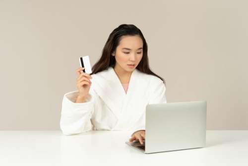 Bothered Young Asian Woman Doing Online Shopping
