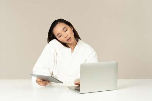 Young Asian Woman Talking On The Phone, Using Tablet And Doing Online Shopping