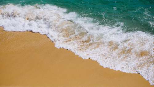 beach sand waves wet ocean