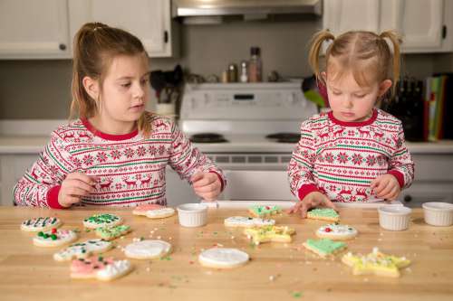 Two Children Decorate Cookies Photo