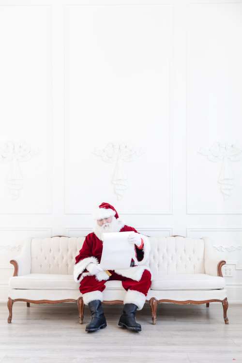 Santa Goes Over Naughty Or Nice List Photo