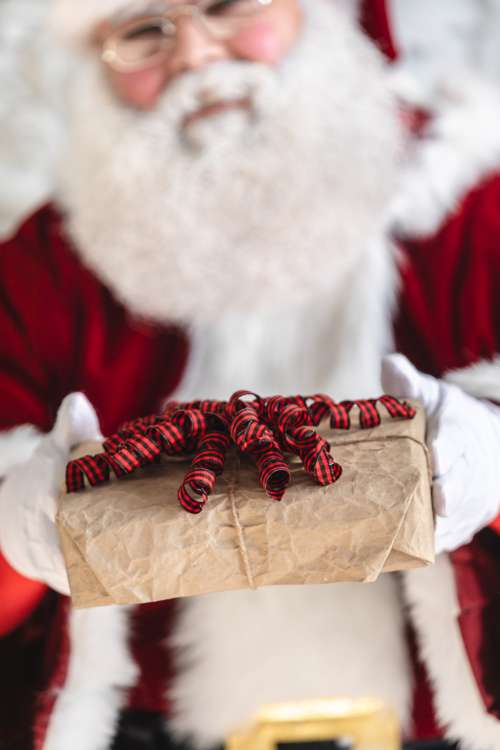 Santa Shows A Newly Wrapped Gfit Photo
