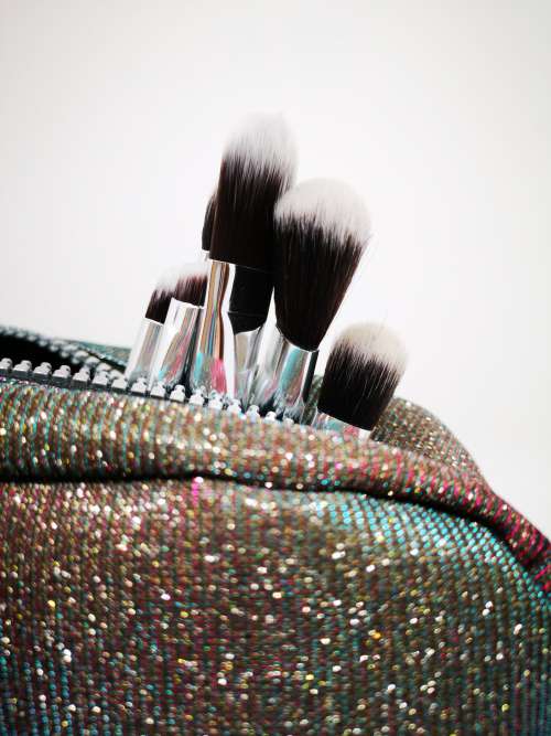 Paint Brushes Burst From A Glittery Handbag Photo