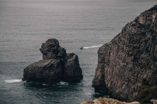 A Dinghy Cuts Through The Grey Sea Photo