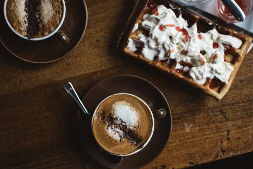 Two coffee cappuccino and waffle