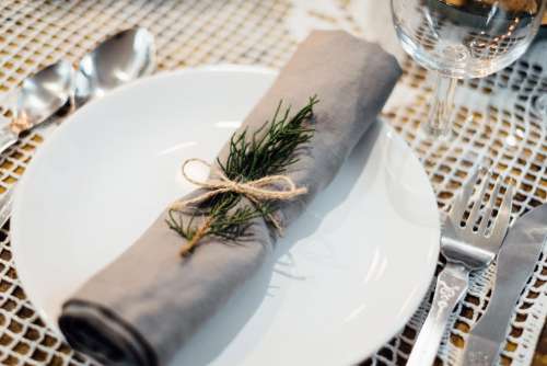 Linen napkin decorated with a conifer twig