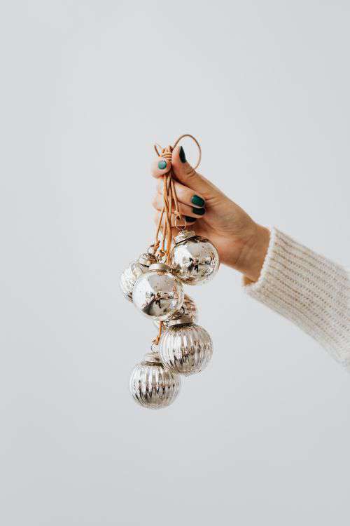 Hand Holding Christmas Tree Baubles