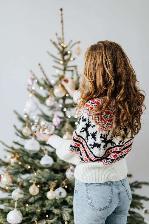 Women Decorate Christmas Trees