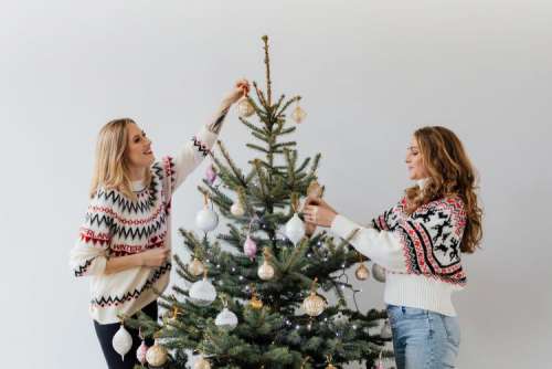 Women Decorate Christmas Trees