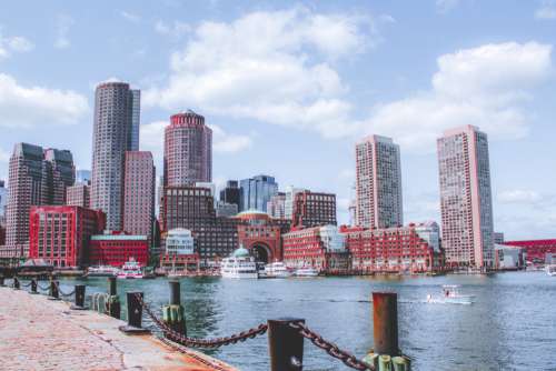 city buildings harbor boats pier