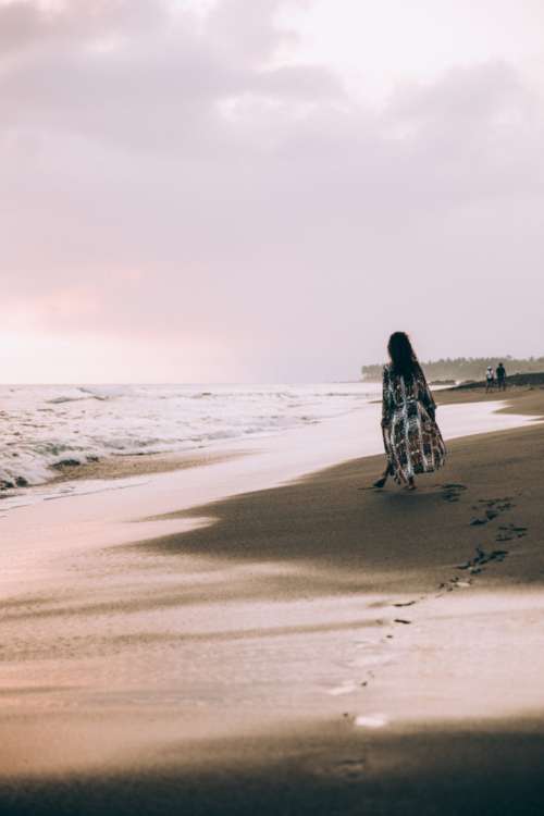 women beach sand ocean waves