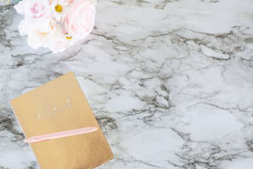 marble background notebook desk flowers